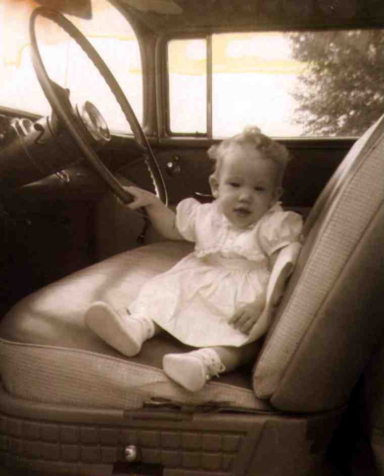 Sandi at age 11 months sitting in the front seat of a 1957 Chevy Bel Air